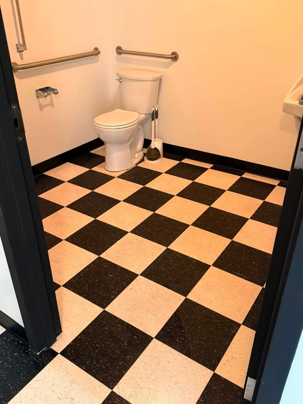 Black and white checkered bathroom floor after cleaning