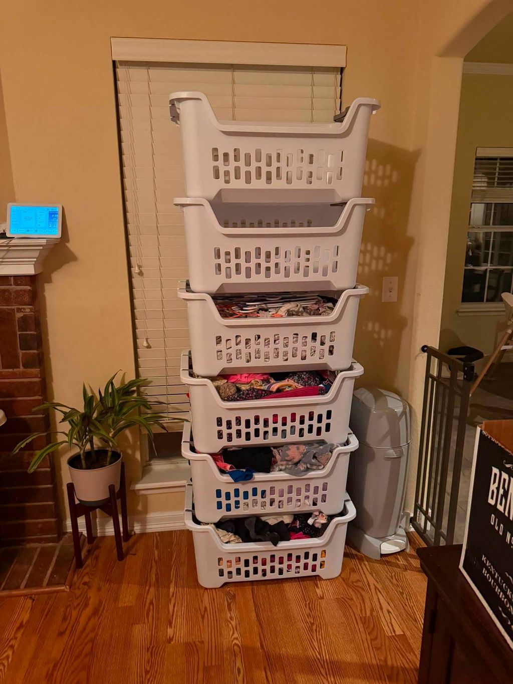Stacked laundry baskets sorted and lined up along a wall